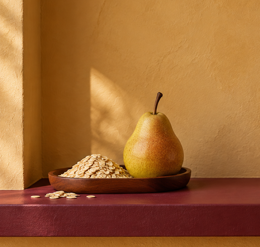 Illustrative oats and a pear in a wooden bowl on a burgundy shelf in an ochre alcove.